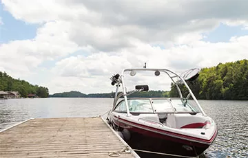 A boat docked on a picturesque lake.